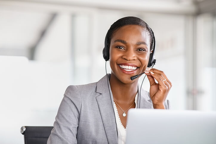 woman with headset on smiling